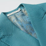 Close-up of the Celeste Whimsy Suit Jacket by KIKI and JOJO in celeste blue, featuring a paisley-patterned blue lining and a visible KIKI and JOJO designer label inside the collar.