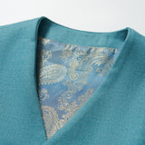 The Celeste Whimsy Suit Vest by KIKI and JOJO is a boys' peacock blue V-neck vest with a blue and gold paisley-patterned lining—ideal for a smart formal look.