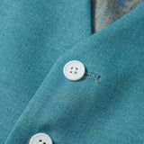 Close-up of two white buttons on peacock blue Celeste Whimsy Suit Vest by KIKI and JOJO, with patterned fabric in background—ideal for a sharp boys' formal look.