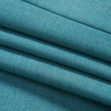 Close-up view of neatly folded teal fabric with visible texture and stitching.