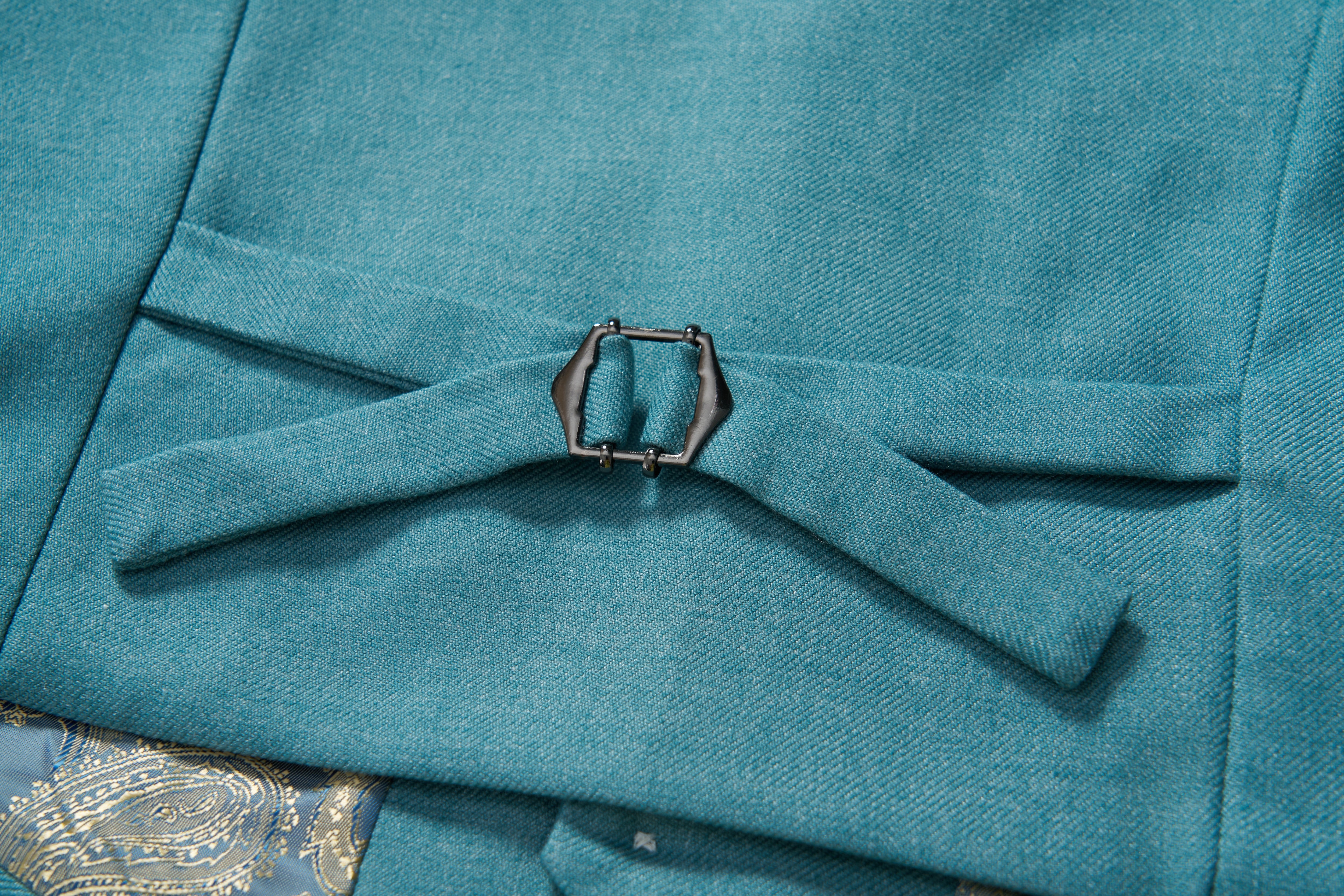 Close-up of the peacock blue fabric belt with metal buckle on the KIKI and JOJO Celeste Whimsy Suit Vest, showing its detailed texture and patterned lining—ideal for creating a polished formal look.