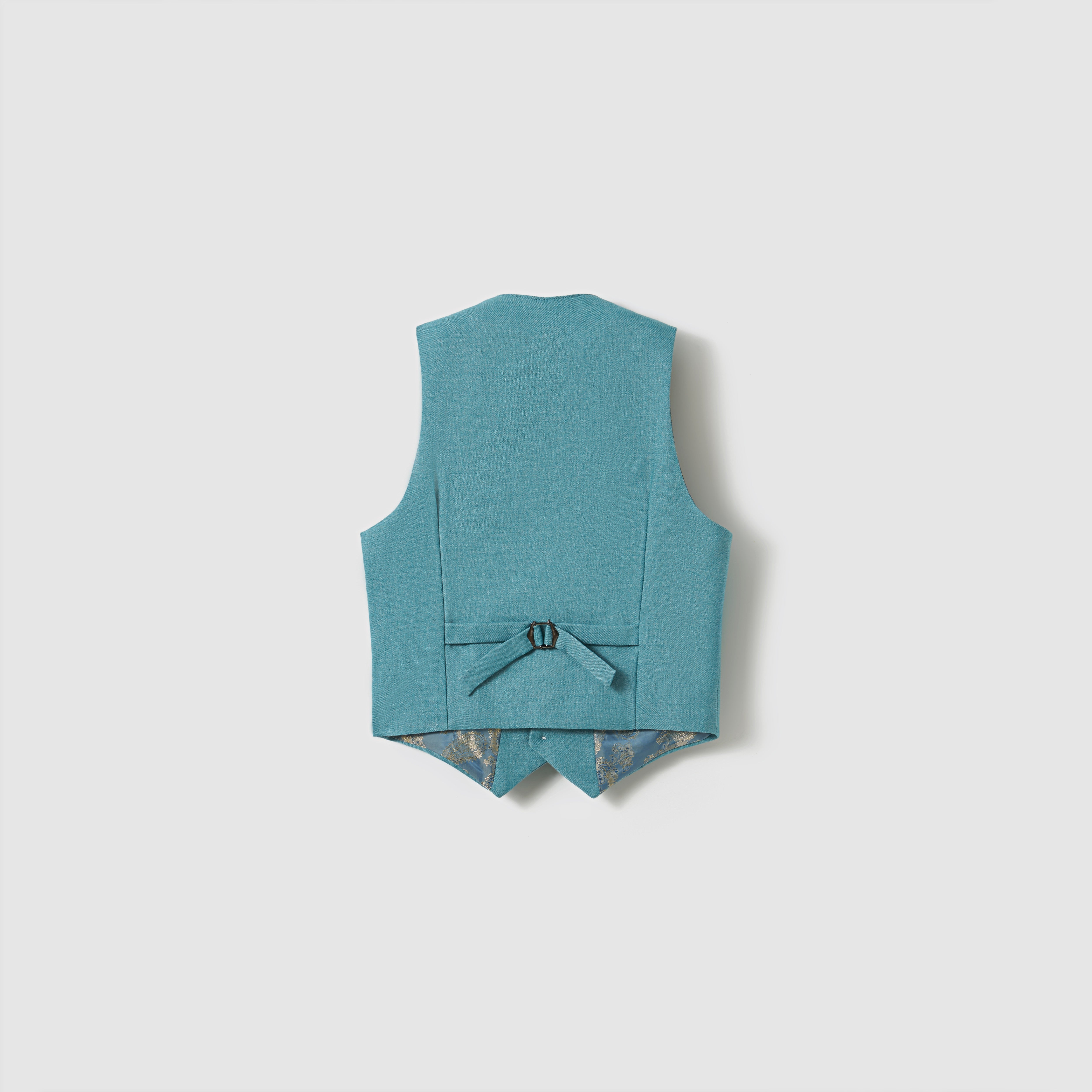 The Celeste Whimsy Suit Vest by KIKI and JOJO is shown from the back in peacock blue, with an adjustable strap and pointed hem against a plain light background—ideal for any formal look.