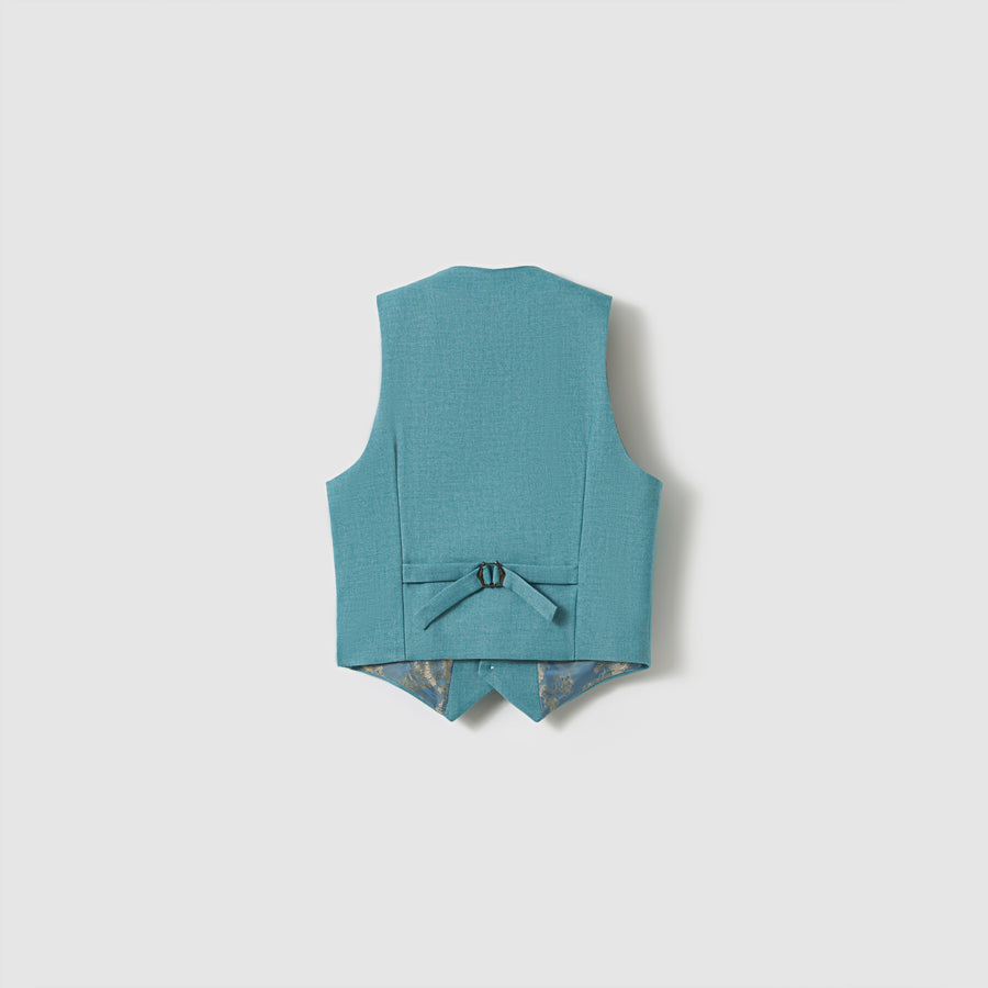 The Celeste Whimsy Suit Vest by KIKI and JOJO is shown from the back in peacock blue, with an adjustable strap and pointed hem against a plain light background—ideal for any formal look.
