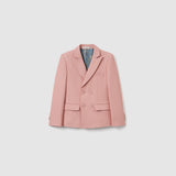 The KIKI and JOJO Blush Reverie Suit Jacket is a blush pink, double-breasted boys blazer with notch lapels, two front flap pockets, and a chest pocket—perfect for special occasions and shown against a plain white background.
