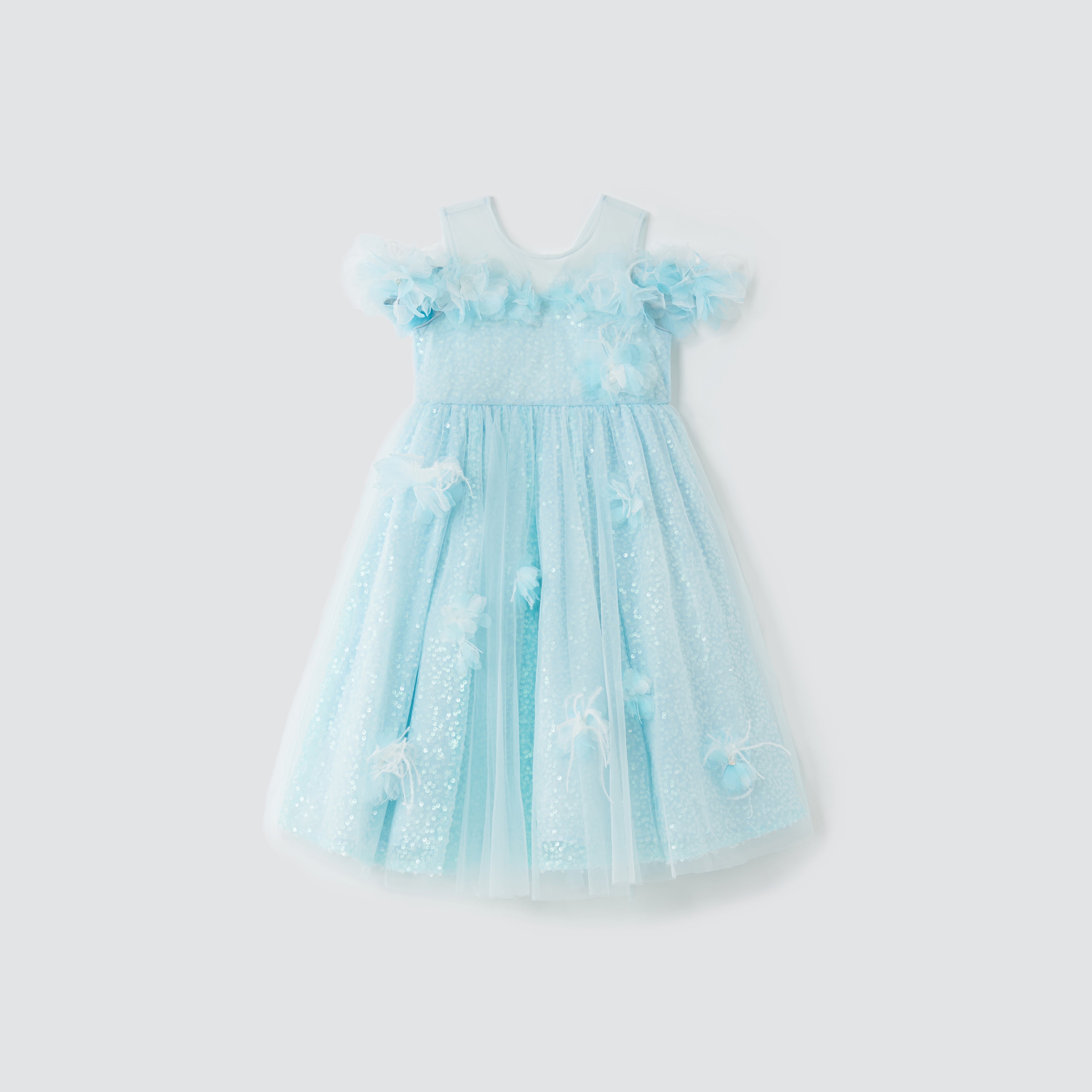 The Feathered Whisper Dress - Blue by KIKI and JOJO is a light blue, sleeveless girl’s dress with tulle overlay, floral appliqués, and sequin details, shown on a plain white background.