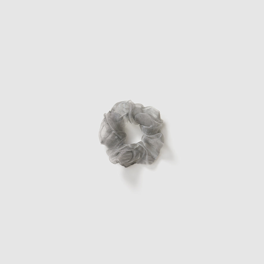 A set of three KIKI and JOJO Girls Mini Pearl Sheen Organza Scrunchies in soft gray, blush pink, and ivory cream is displayed on a plain light gray background.