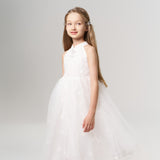 A young girl with long hair wears KIKI and JOJO's Girls Crystal Garden Barrettes (set of 2), a sleeveless white dress, and silver shoes, standing and smiling against a plain light background.