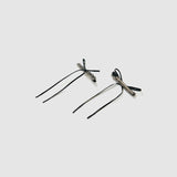 The KIKI and JOJO Girls Black Beaded Bow Hair Clips (Set of 2) feature stylish black bows with silver embellishments, perfect for accessorizing. Each set includes a gift pouch for elegant gifting.