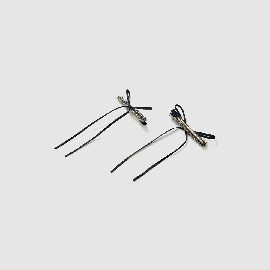 The KIKI and JOJO Girls Black Beaded Bow Hair Clips (Set of 2) feature stylish black bows with silver embellishments, perfect for accessorizing. Each set includes a gift pouch for elegant gifting.