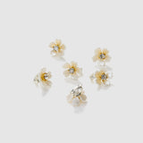 The KIKI and JOJO Girls Daisy Crystal Flower Hair Clips set includes 6 white flower-shaped clips with gold centers and clear stones—ideal as charming flower girl hair accessories.