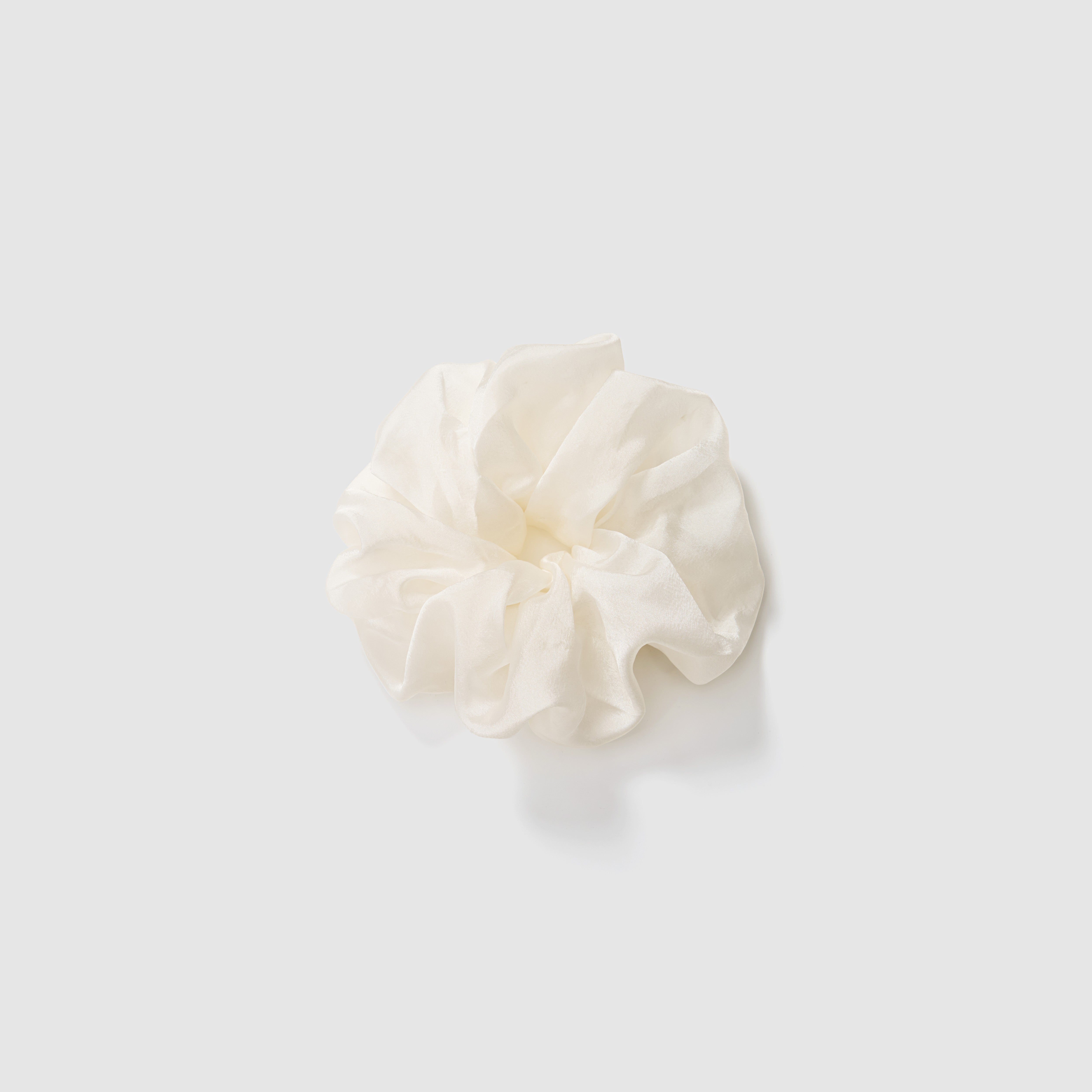The KIKI and JOJO Girls Cloud White Organza Scrunchie, ideal as a bridal hair accessory, is displayed on a simple light grey background.