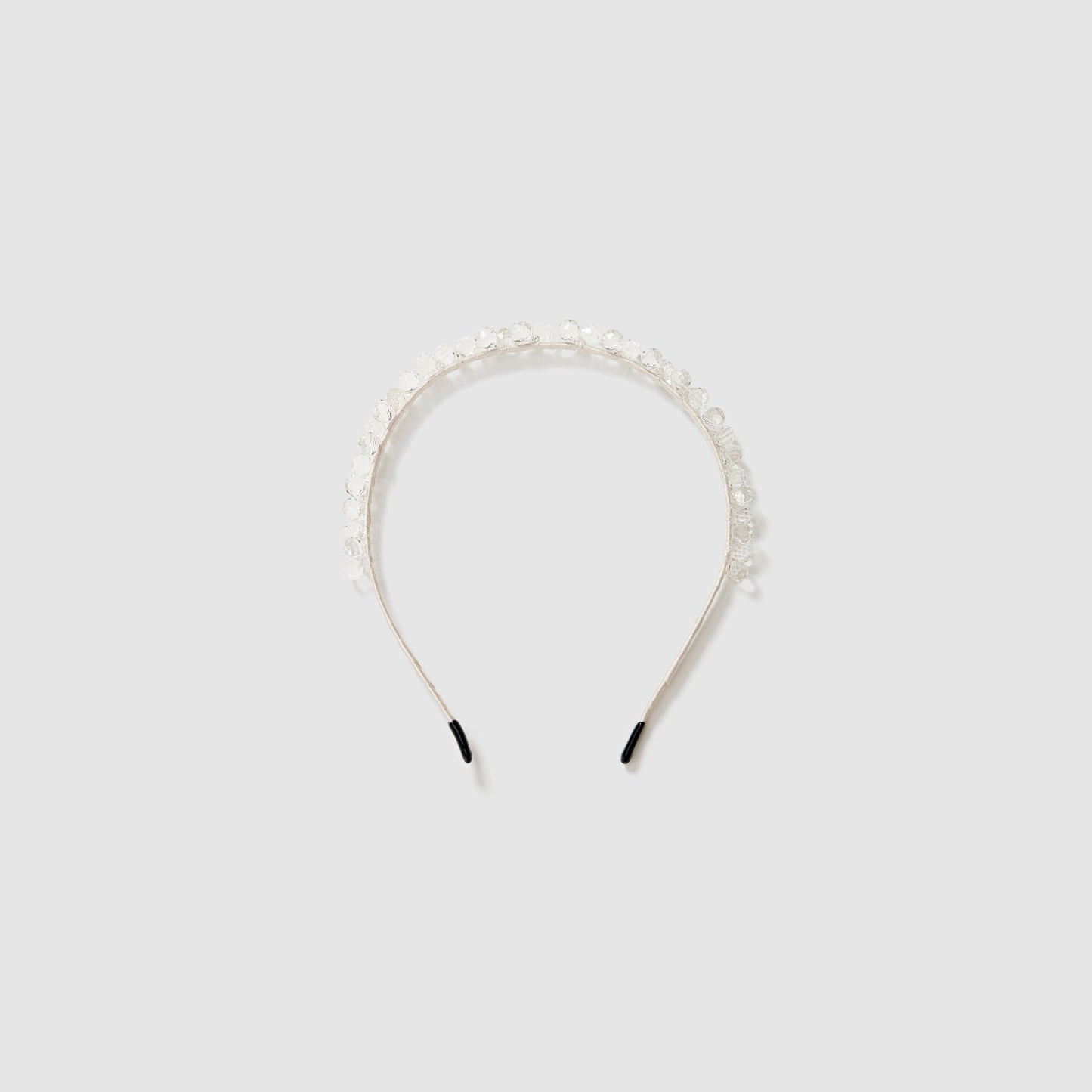 The KIKI and JOJO Girls Crystal Bead Headband features clear and white beads, making it a charming flower girl accessory. Shown on a light gray background.