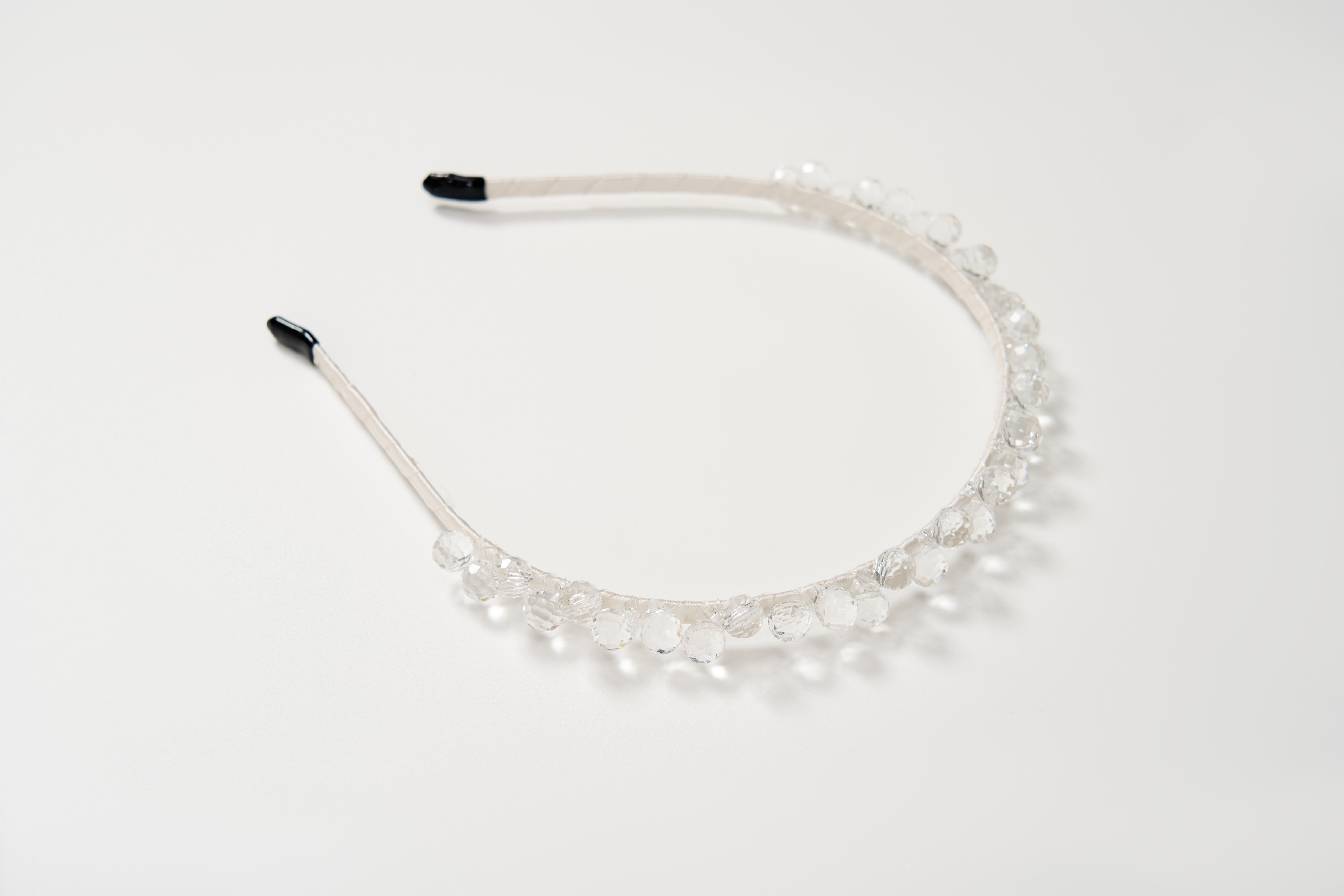 The KIKI and JOJO Girls Crystal Bead Headband, featuring clear round beads, makes a perfect birthday party hairpiece and is shown on a plain white background.