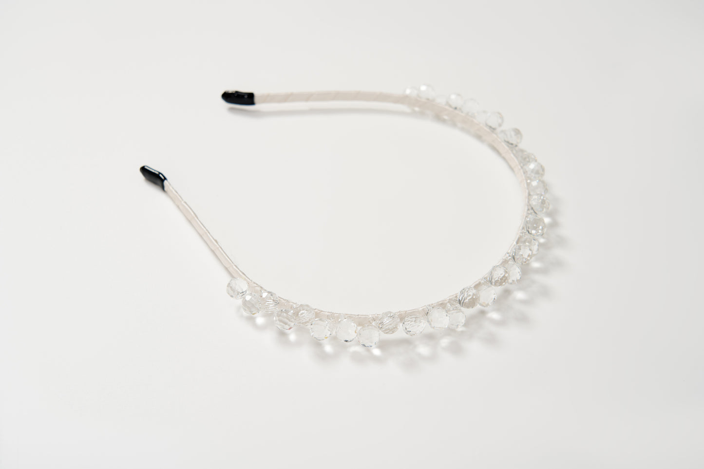 The KIKI and JOJO Girls Crystal Bead Headband, featuring clear round beads, makes a perfect birthday party hairpiece and is shown on a plain white background.