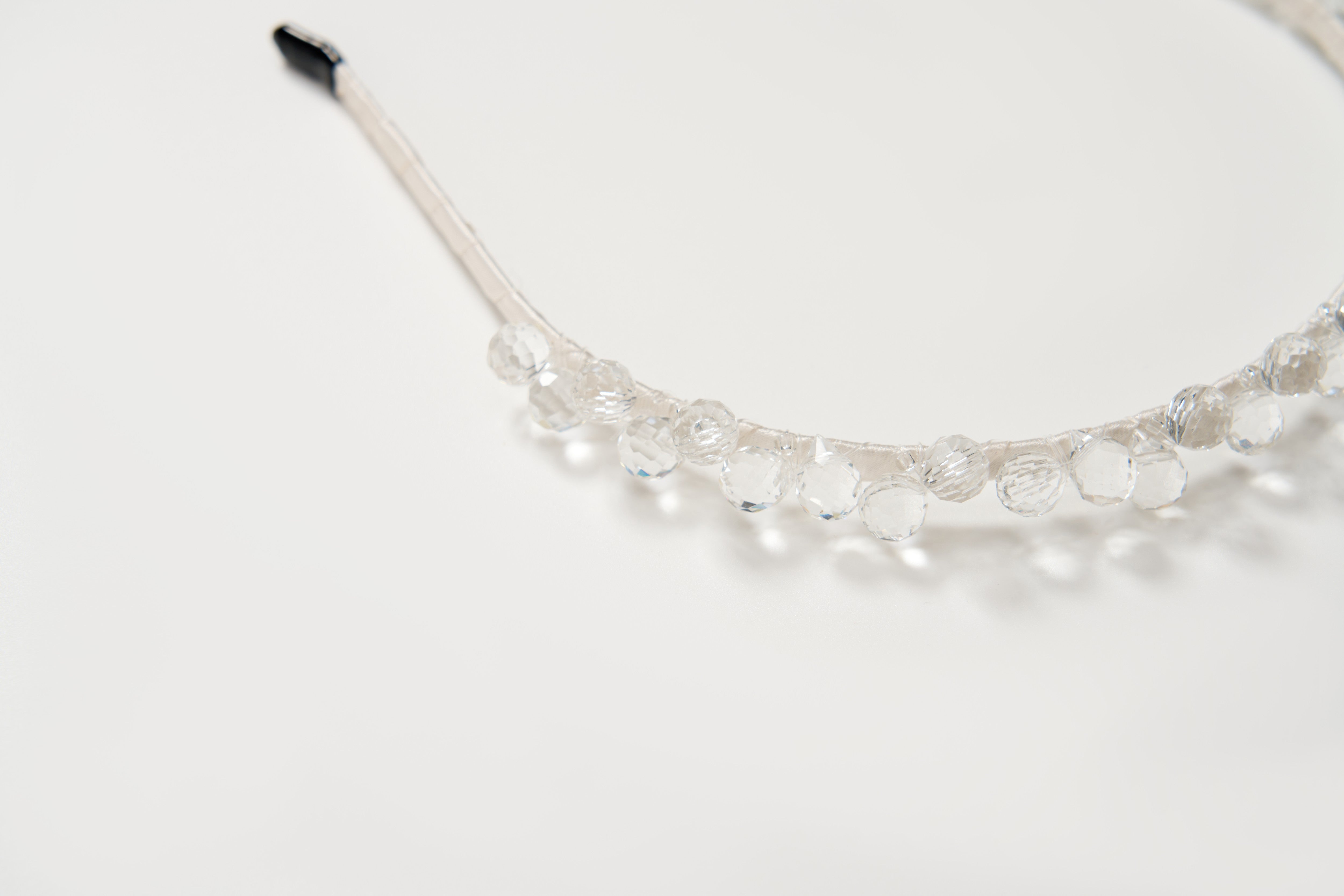 A close-up of the KIKI and JOJO Girls Crystal Bead Headband, featuring clear faceted beads, perfect as a flower girl accessory or birthday party hairpiece, displayed on a plain white background.