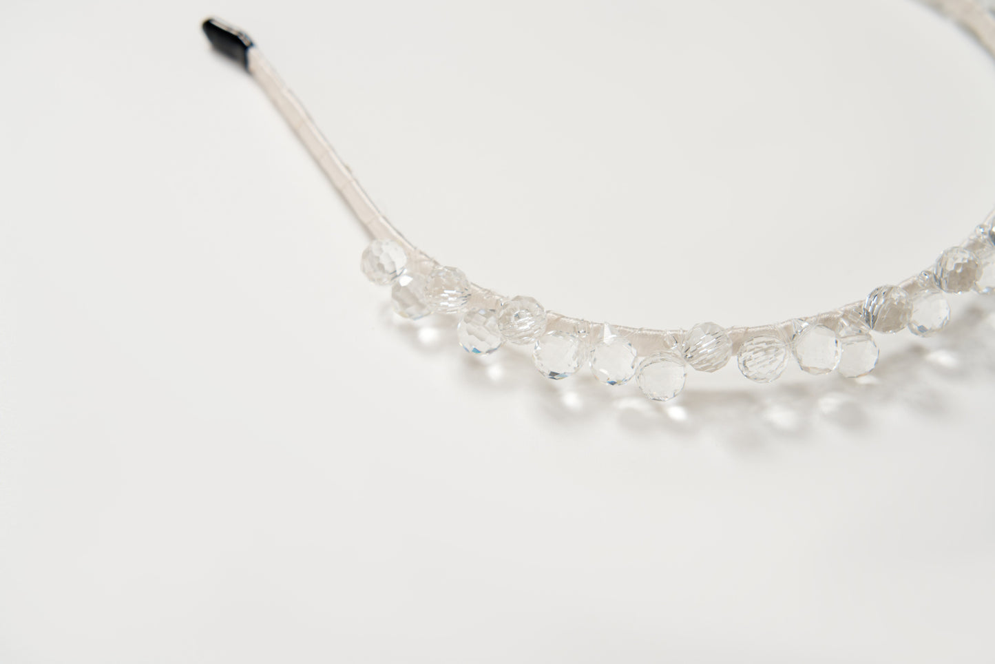 A close-up of the KIKI and JOJO Girls Crystal Bead Headband, featuring clear faceted beads, perfect as a flower girl accessory or birthday party hairpiece, displayed on a plain white background.