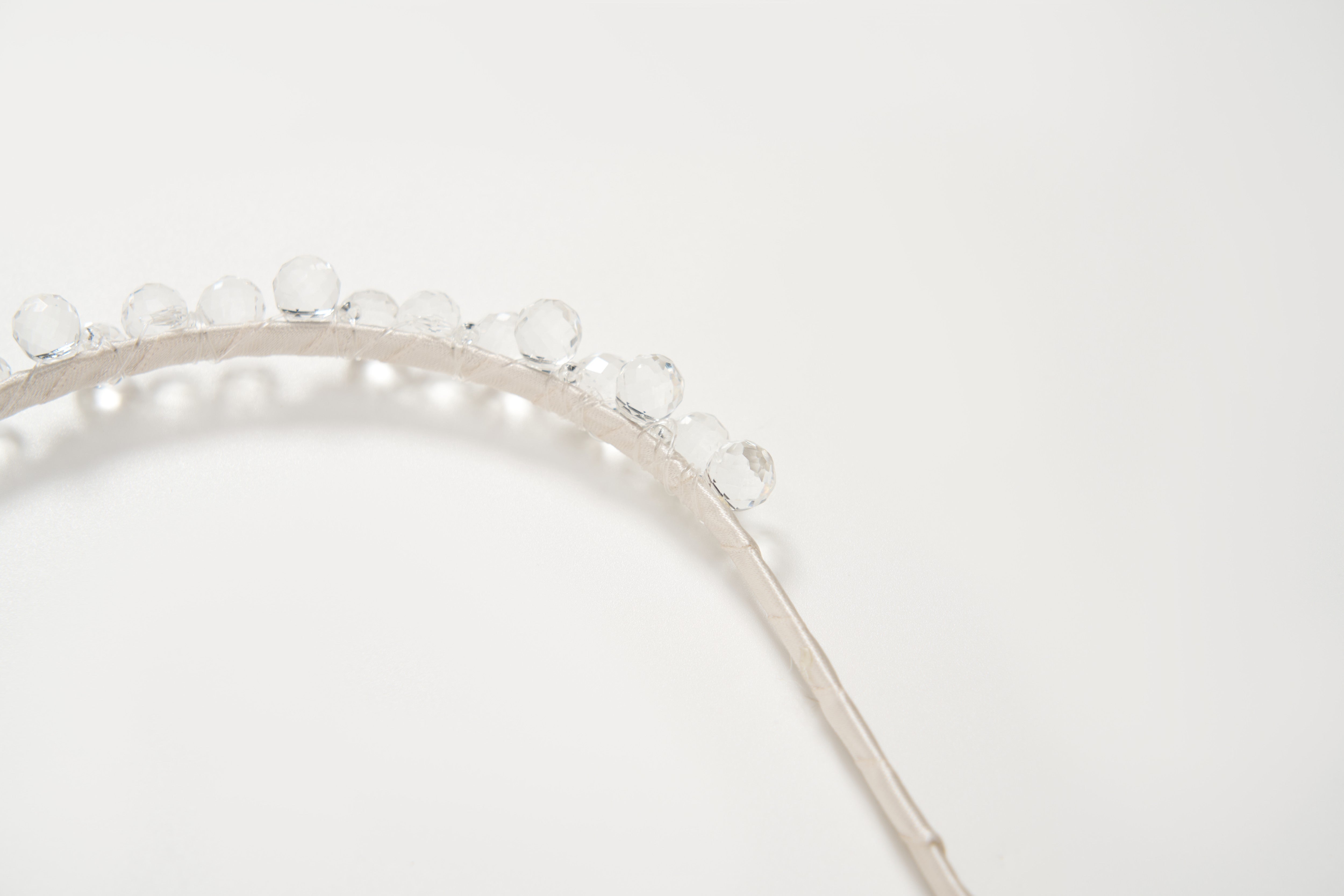 The KIKI and JOJO Girls Crystal Bead Headband, shown on a white background, features silver accents and clear round beads—an ideal accessory for flower girls or birthday parties.