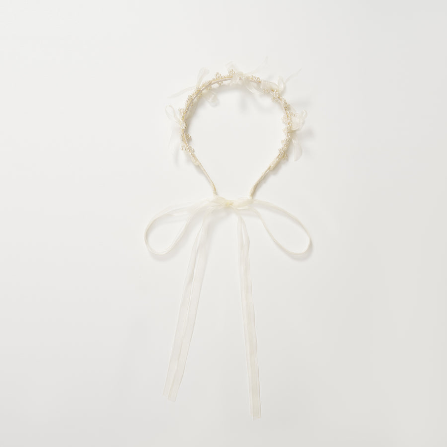 The KIKI and JOJO Girls Pearl Bow Crown Headband features delicate organza bows and white ribbon ties, arranged in a circular shape on a plain white background.
