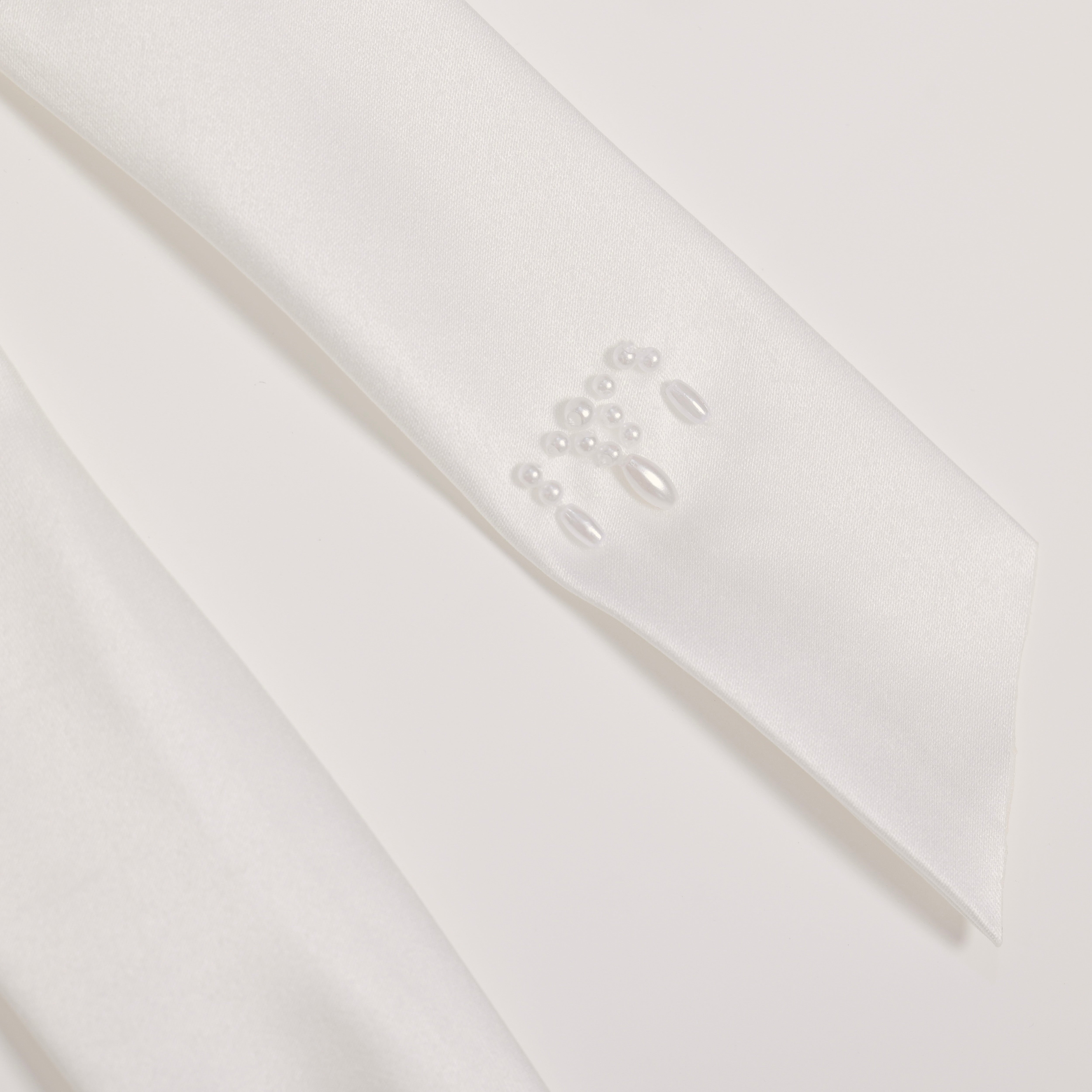 The Girls Hand-Beaded Pearl Satin Bow Hair Clip by KIKI and JOJO features pearls and beads like a pearl accessory, shown on a plain white background.