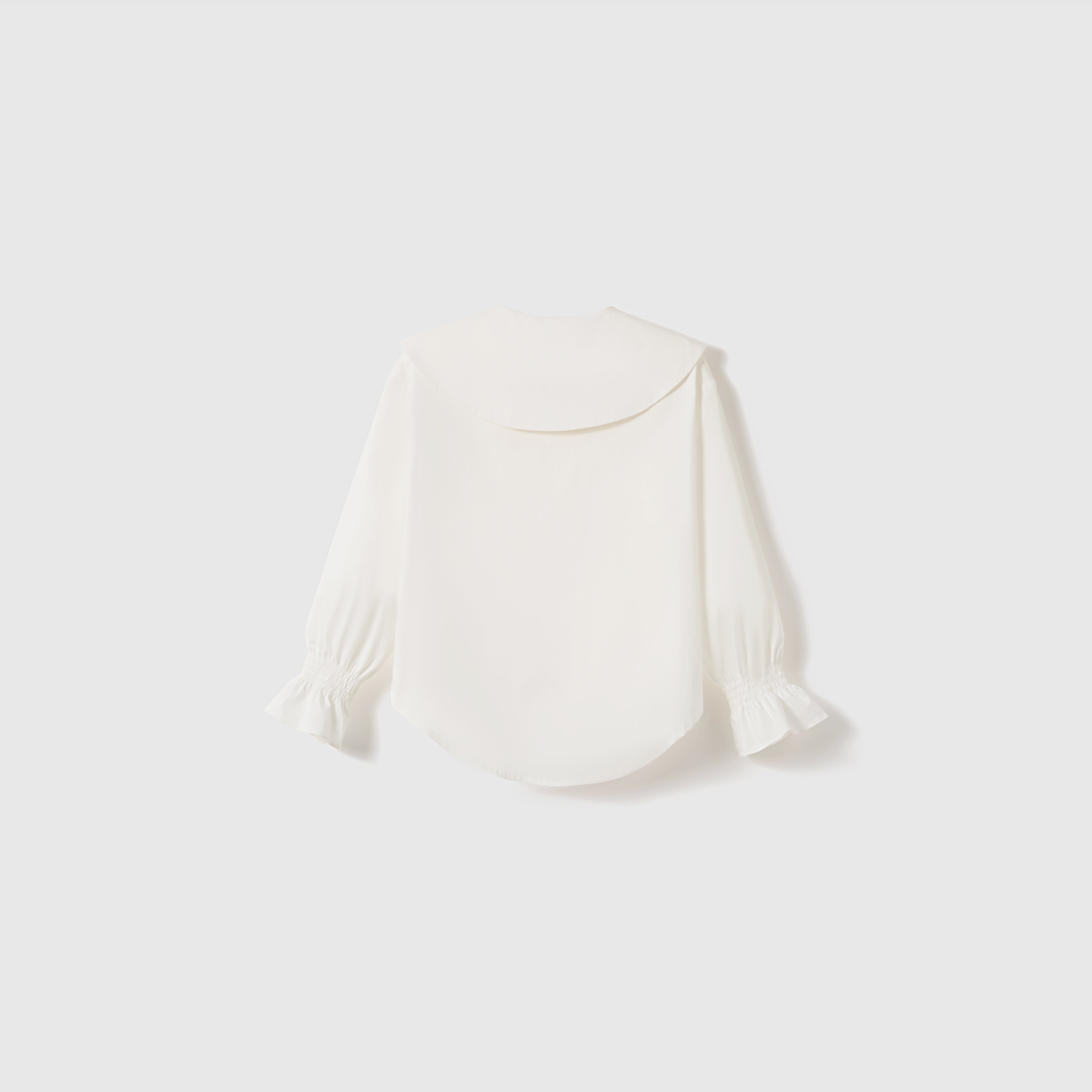 The KIKI and JOJO Moonlit Whisper Blouse features puffed lantern sleeves, a large scalloped collar, and ruffled cuffs, shown against a plain light background.