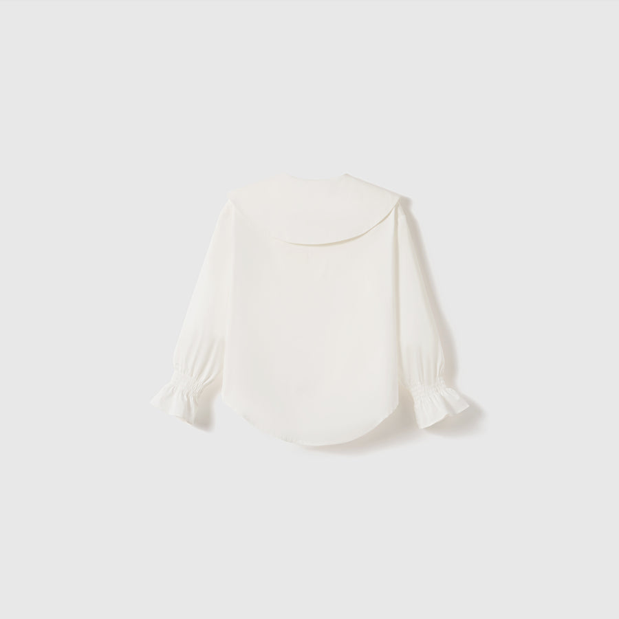 The KIKI and JOJO Moonlit Whisper Blouse features puffed lantern sleeves, a large scalloped collar, and ruffled cuffs, shown against a plain light background.