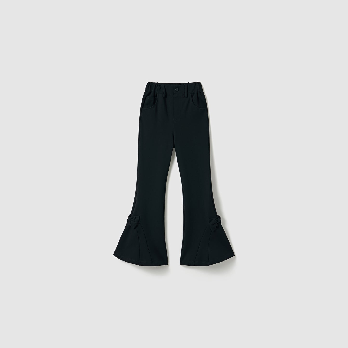 The Petal Whisper Dress Pants by KIKI and JOJO are flared black pants with an elastic waistband, side pockets, and bow accents at the lower legs, crafted from stretchy fabric and shown against a plain light background.