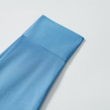 A close-up of the KIKI and JOJO Boys Sky Blue Dress Shirt, neatly folded with visible stitching, displayed on a white background.
