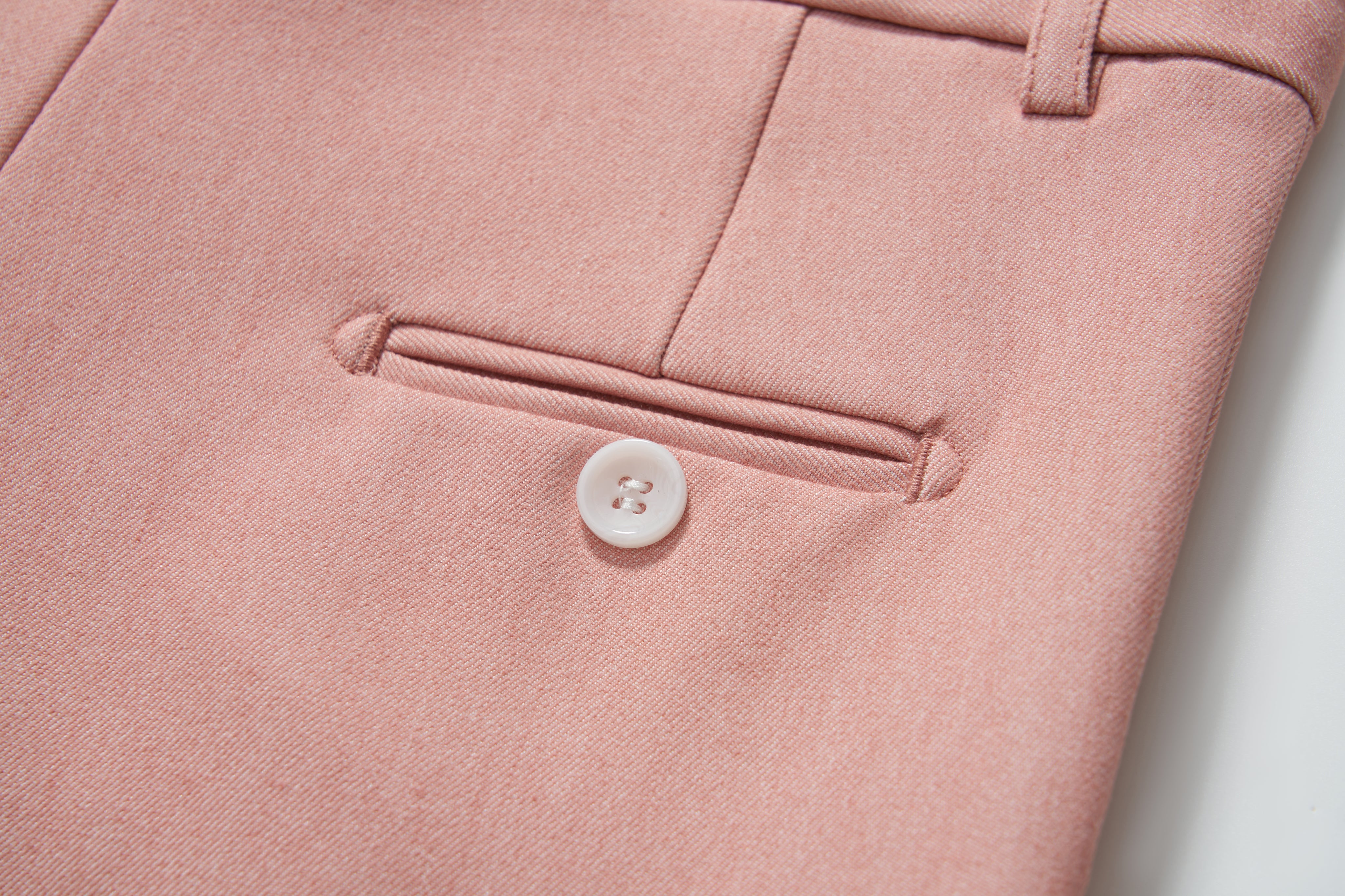 Close-up of KIKI and JOJO Blush Reverie Suit Pants for boys, showing a pocket with white button, belt loop, and adjustable waistband for a perfect fit.