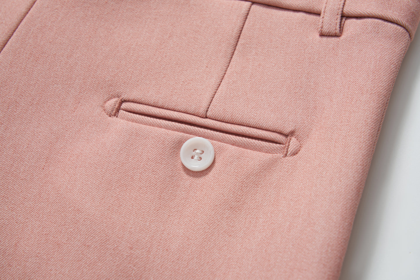 Close-up of KIKI and JOJO Blush Reverie Suit Pants for boys, showing a pocket with white button, belt loop, and adjustable waistband for a perfect fit.