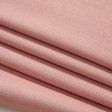 Close-up of four neatly folded layers of soft, light pink fabric with a smooth, fine texture.