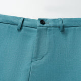 Close-up of KIKI and JOJO’s Celeste Whimsy Suit Pants for boys in turquoise, showcasing a button closure, belt loops, adjustable waistband, and front seam detail on a white background.