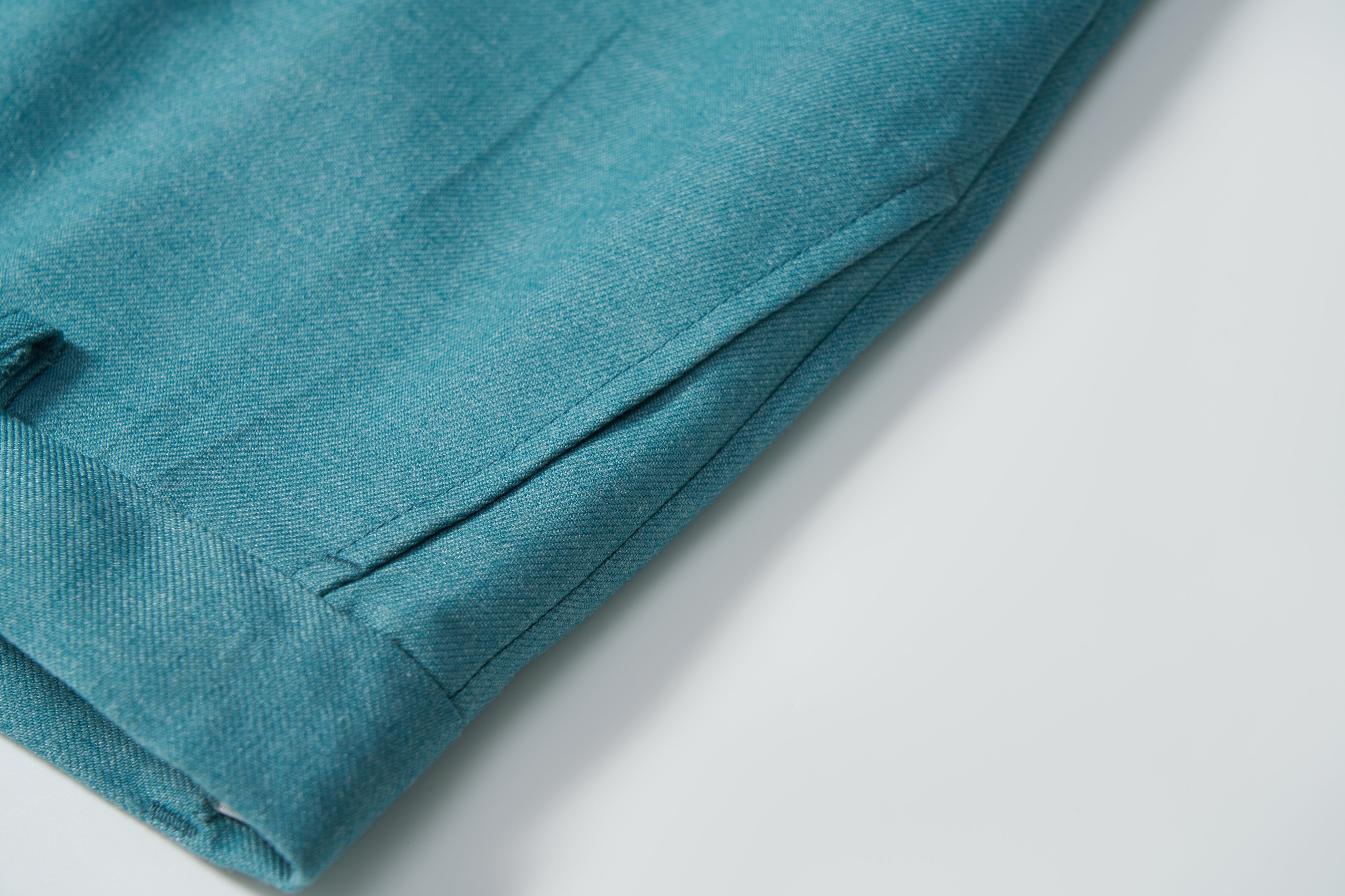 Close-up of KIKI and JOJO’s Celeste Whimsy Suit Pants for boys, showcasing a cuffed hem, adjustable waistband, and side pocket, photographed against a plain light background.
