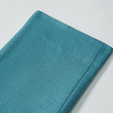A close-up of the neatly folded Celeste Whimsy Suit Pants by KIKI and JOJO displayed on a white surface.