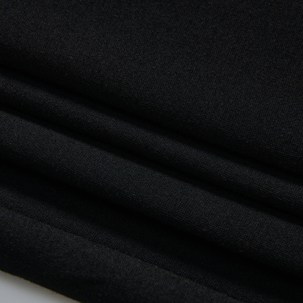 Close-up of neatly folded black fabric, showing smooth texture and clean lines.