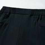 Close-up of KIKI and JOJO’s Echo Whisper Dress Pants featuring a flared black design, elastic waistband, and two side pockets, shown on a white background.