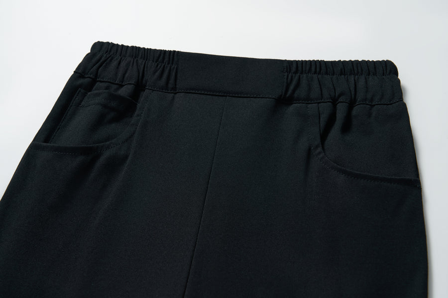 Close-up of KIKI and JOJO’s Echo Whisper Dress Pants featuring a flared black design, elastic waistband, and two side pockets, shown on a white background.