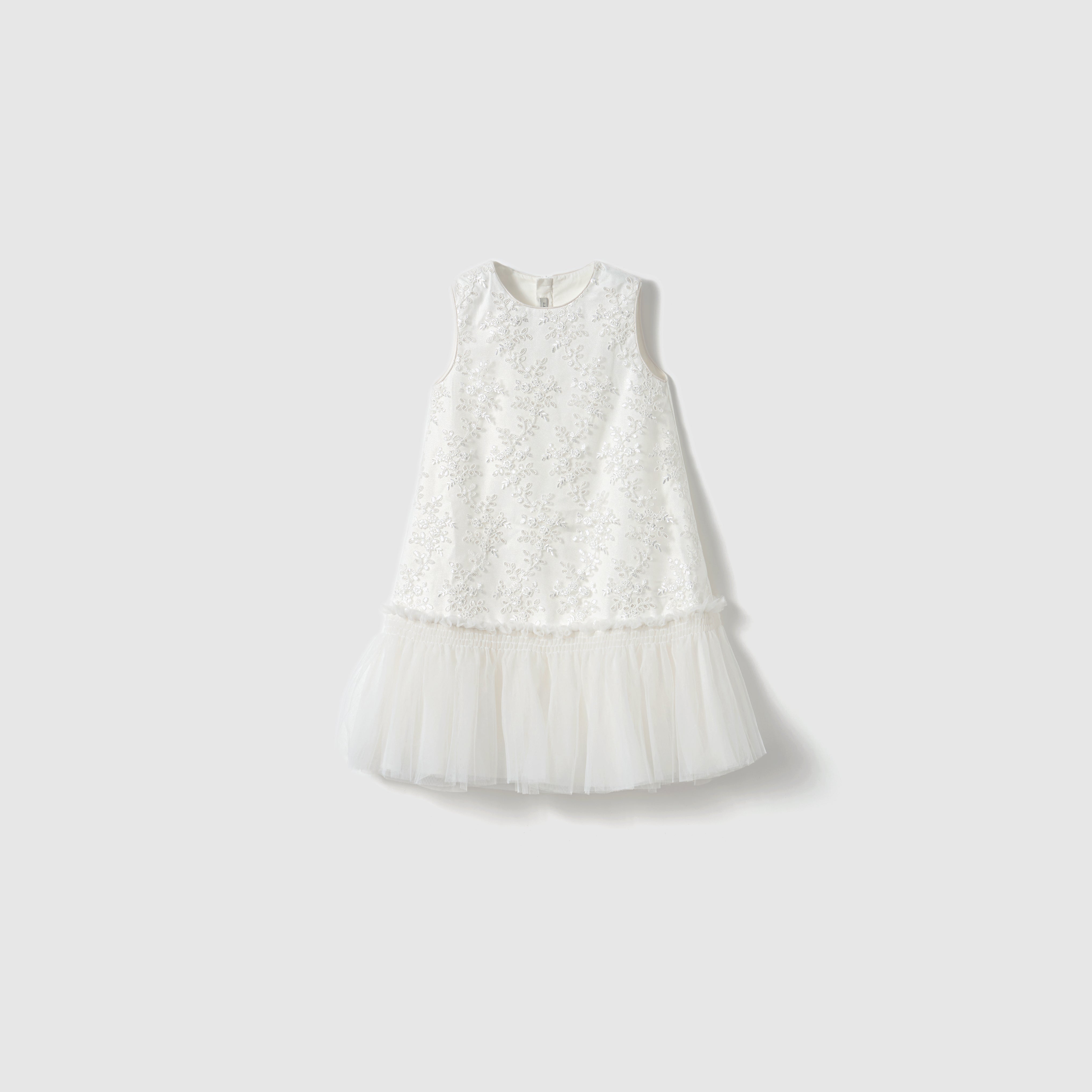 The Twinkle Whisper Dress by KIKI and JOJO features a sleeveless embroidered lace bodice and a tulle skirt, shown against a plain light background.