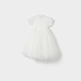 The Whisper Bloom Dress by KIKI and JOJO is a white, knee-length mini dress with short puffed sleeves, floral embroidery, bead accents, a fitted bodice, and a full tulle skirt shown against a plain white background.