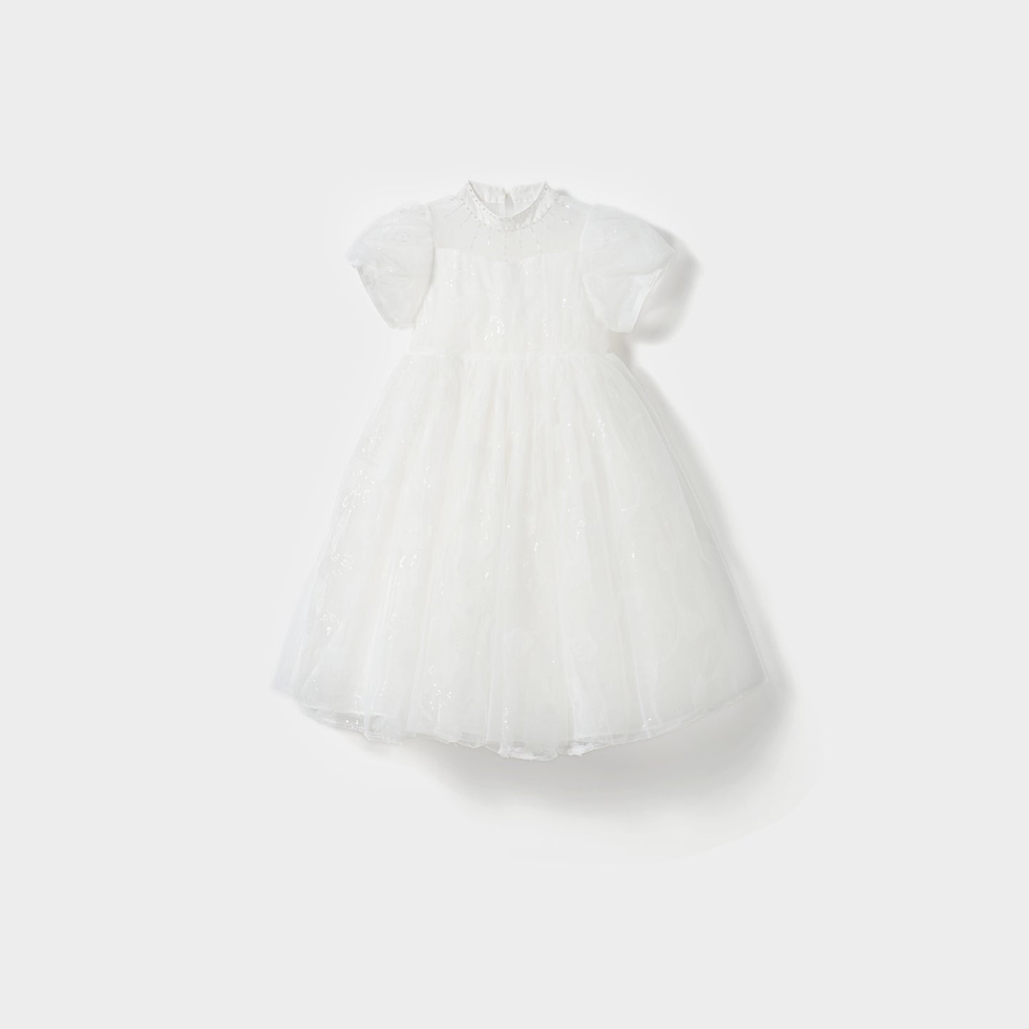 The Whisper Bloom Dress by KIKI and JOJO is a white, knee-length mini dress with short puffed sleeves, floral embroidery, bead accents, a fitted bodice, and a full tulle skirt shown against a plain white background.