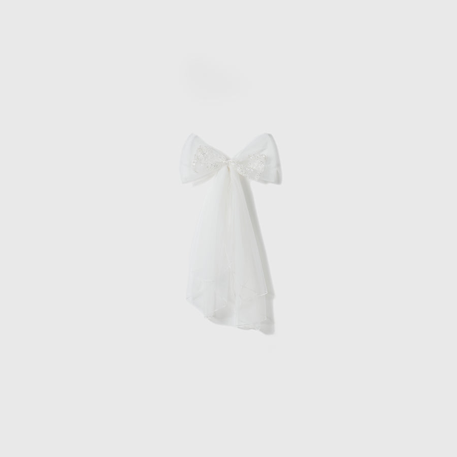 The Twinkle Whisper Dress by KIKI and JOJO features sheer fabric, decorative beading, and delicate embroidered lace, beautifully displayed against a plain light gray background.