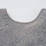 Close-up of the Dusk Whisper Dress by KIKI and JOJO, showcasing its textured grey fabric, tulle puff sleeves, and rounded neckline against a plain white background.