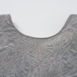 Close-up of the Dusk Whisper Dress by KIKI and JOJO, featuring a grey puff-sleeve design with a scoop neckline and sheer ruffled sleeves, displayed on a white background.