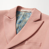 The KIKI and JOJO Blush Reverie Suit Jacket is a blush pink boys’ double-breasted blazer with a notched lapel and blue-gold patterned inner lining, displayed on a white background—ideal for special occasions.