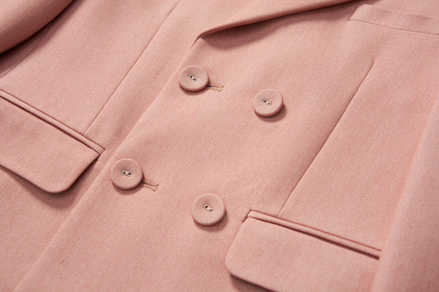 Close-up of the KIKI and JOJO Blush Reverie Suit Jacket, a blush pink, double-breasted boys blazer with lapel and two front pockets—perfect for special occasions.