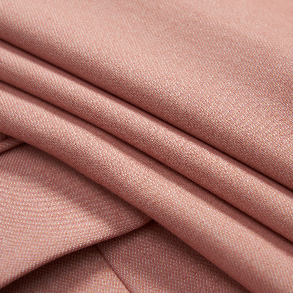 Close-up of folded light pink fabric with a smooth texture and subtle diagonal weave pattern.