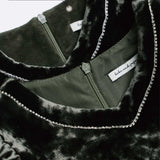 Close-up of the KIKI and JOJO Girls Velvet Puff Sleeve Dress in Forest Green, featuring rhinestone trim, green zipper, and fleece-lined lining—perfect for special occasions.