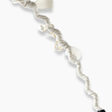 The KIKI and JOJO Girls Bow Hairband - Pearl features a twisted white fabric with bow details, pearl-like beads, and a black teardrop ornament at one end, shown on a white background.