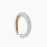 The KIKI and JOJO Girls Diamanté Padded Hairband in ivory, featuring sparkling diamantés and a quilted design, is displayed against a plain white background.