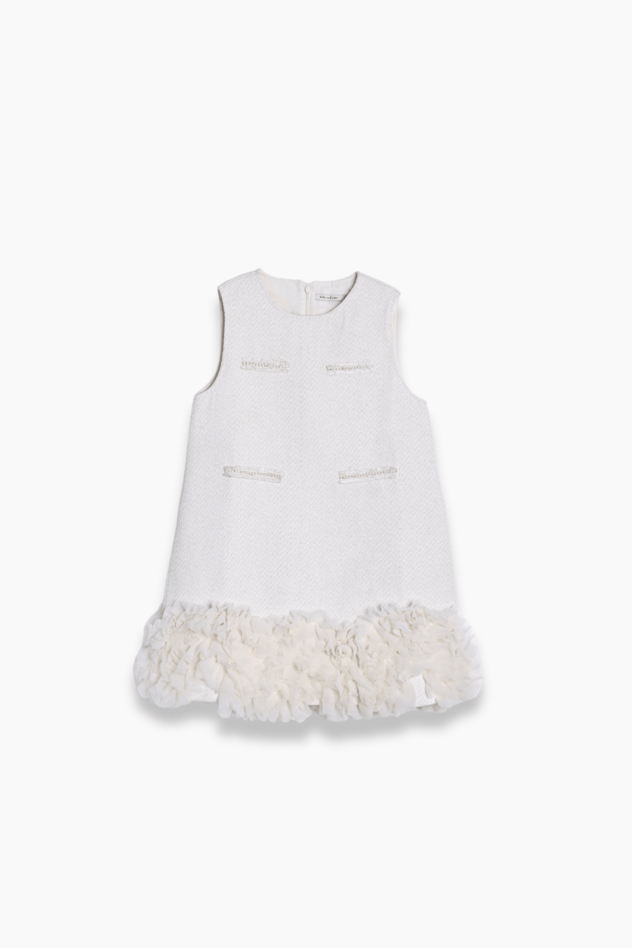 The KIKI and JOJO Girls Elegance A-Line Chiffon Trim Dress in Champagne features a sleeveless design, textured fabric, front decorative pockets, and delicate ruffled chiffon trim at the hem.
