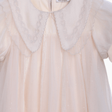 The KIKI and JOJO Girls Embroidered Satin Collar Sparkle Tulle Dress in Beige/Ivory features a sheer overlay, puffed short sleeves, a scalloped embroidered satin collar, and a back zipper.